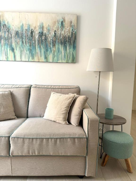 a living room with a couch and a table at Starhost - CASA BONNIE, large furnished balcony on the Cathedral and a stone's throw from seafront, beach and ferry's pier in Minori
