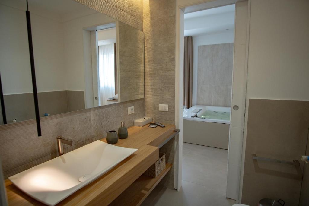 a bathroom with a sink and a mirror at B&B Le Muse in Mondello