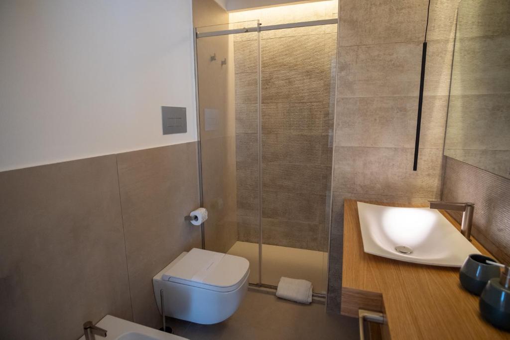 a bathroom with a sink and a toilet and a shower at B&B Le Muse in Mondello