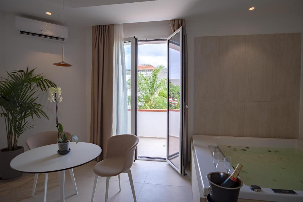 a kitchen with a table and a white table and chairs at B&B Le Muse in Mondello