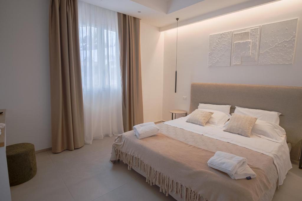 a bedroom with a bed with two towels on it at B&B Le Muse in Mondello