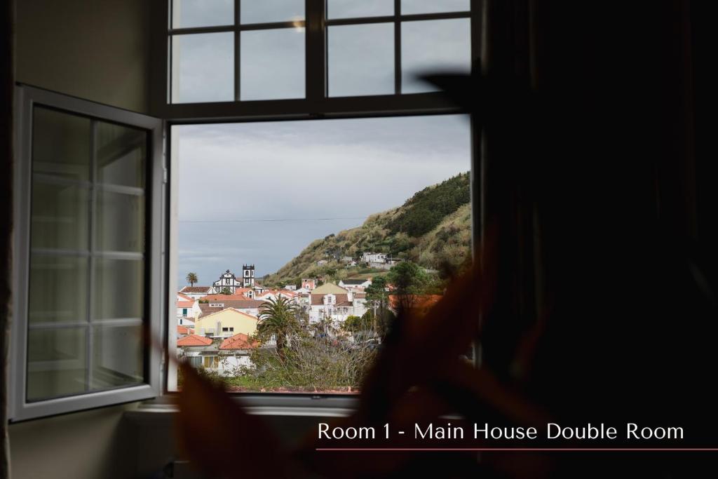 a window with a view of a town at Solar de Lalém in Maia
