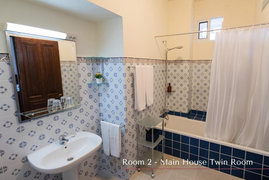 a bathroom with a sink and a toilet and a tub at Solar de Lalém in Maia