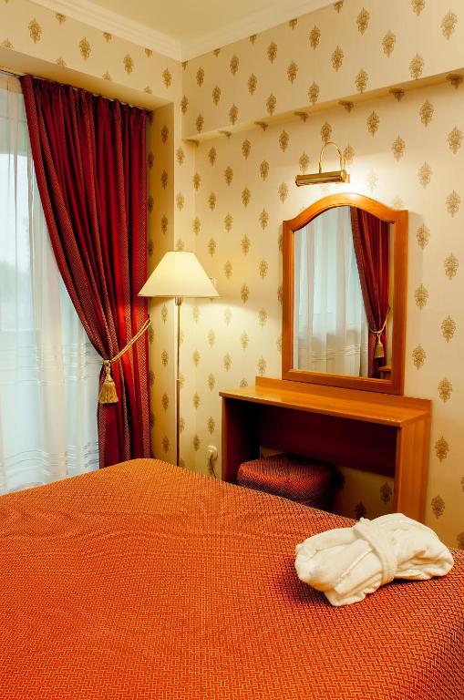 Postel nebo postele na pokoji v ubytování Astana International Hotel