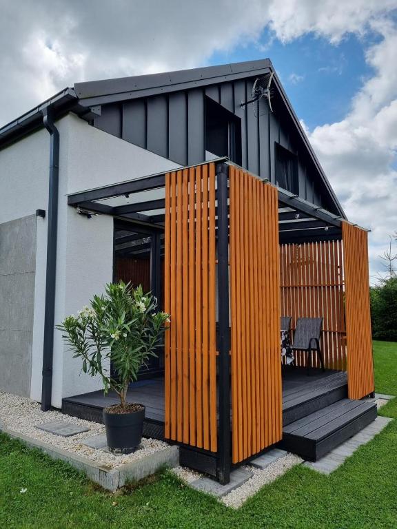 a house with an orange and black facade at M&M House in Okuninka