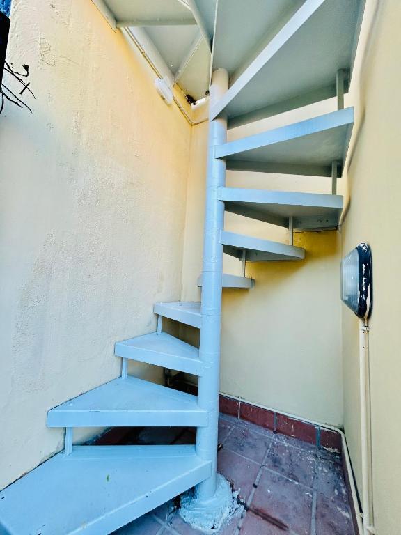 a blue staircase in a room with a wall at La Gaetana in Gaeta