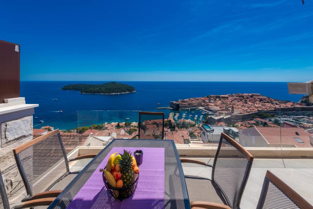 a table with a bowl of fruit on a balcony at Villa Dommy Gabby in Dubrovnik