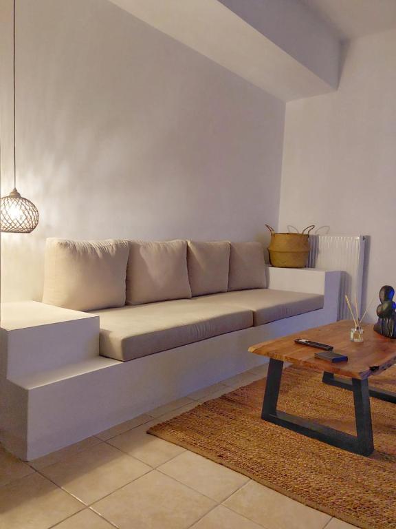 a living room with a couch and a coffee table at Sofianna's oasis in Kalloni Tinou