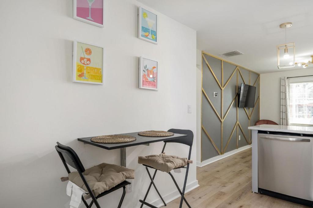 a small kitchen with a table and two chairs at Chic 2-Bed Haven with Vibrant Décor in SE Atlanta in Atlanta