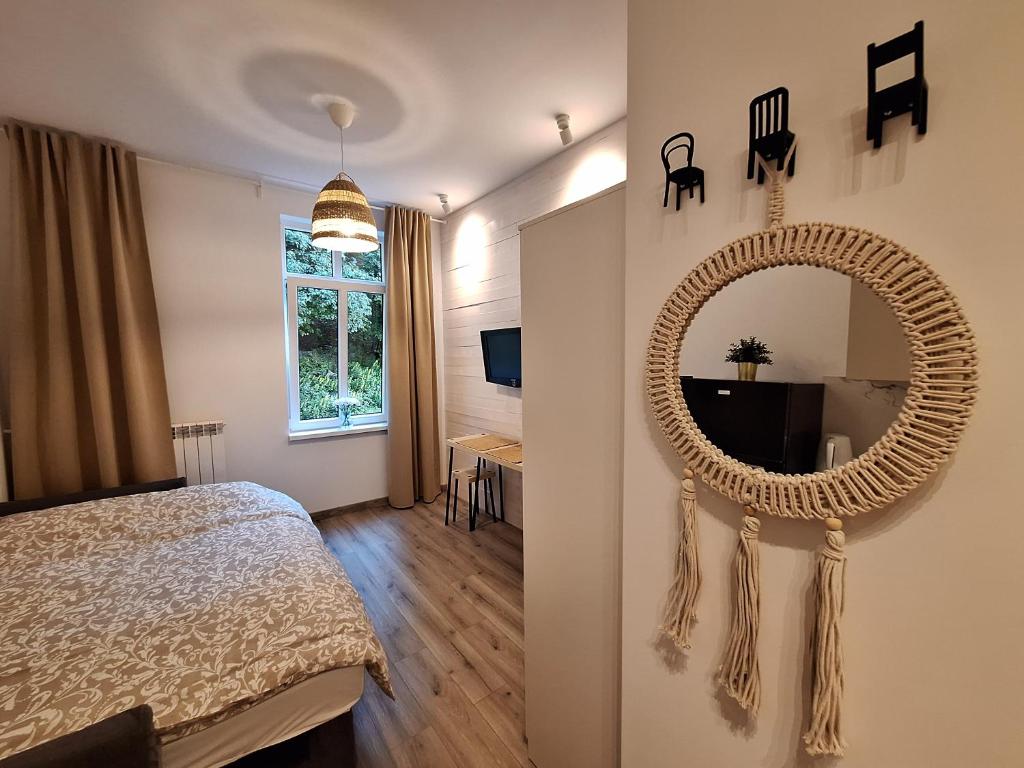 a bedroom with a large mirror on the wall at Apartamencik Zofiówka in Iwonicz-Zdrój