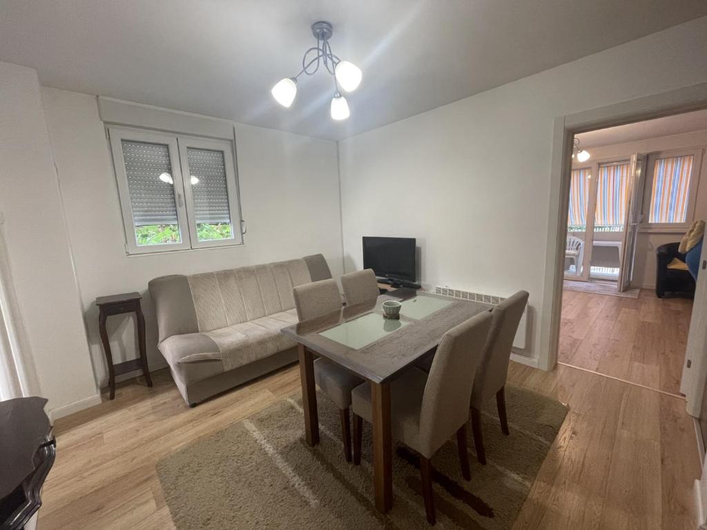 a living room with a table and a couch at Apartment La Romana in Podgorica