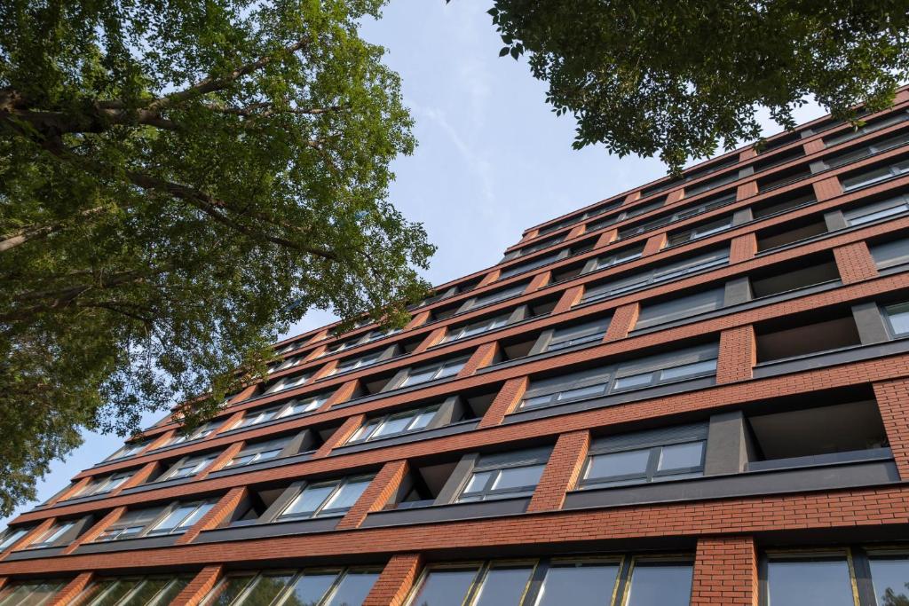 a tall red brick building with lots of windows at Lux Mila with Free Private parking in Novi Sad