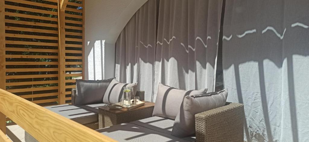 a balcony with chairs and a table with birds on the wall at Holiday house Zlata in Banjol
