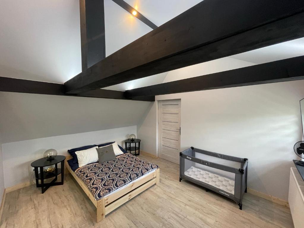 a bedroom with a bed and a loft at Apartament u Teresy in Harkabuz