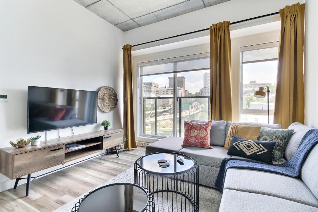 a living room with a couch and a flat screen tv at Penthouse, near old city in Quebec City