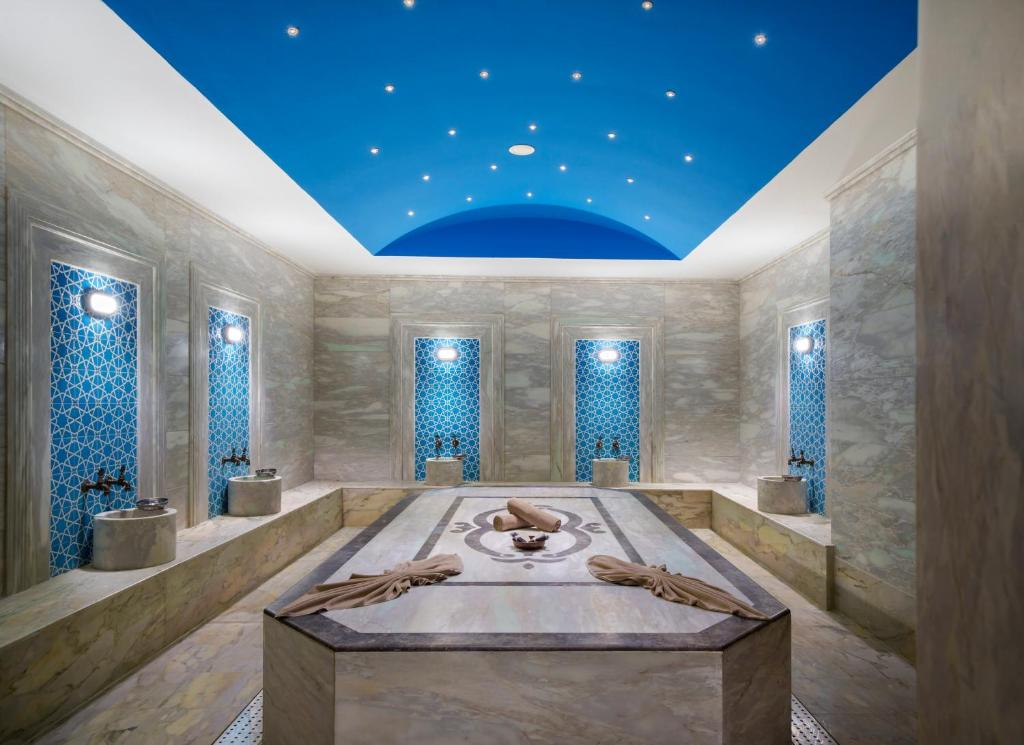 a room with a bath tub with a blue ceiling at Liberty Kuşadası in Kusadası