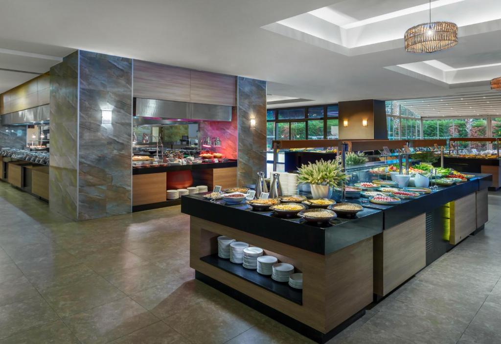 a buffet line in a restaurant with food on display at Liberty Kuşadası in Kusadası