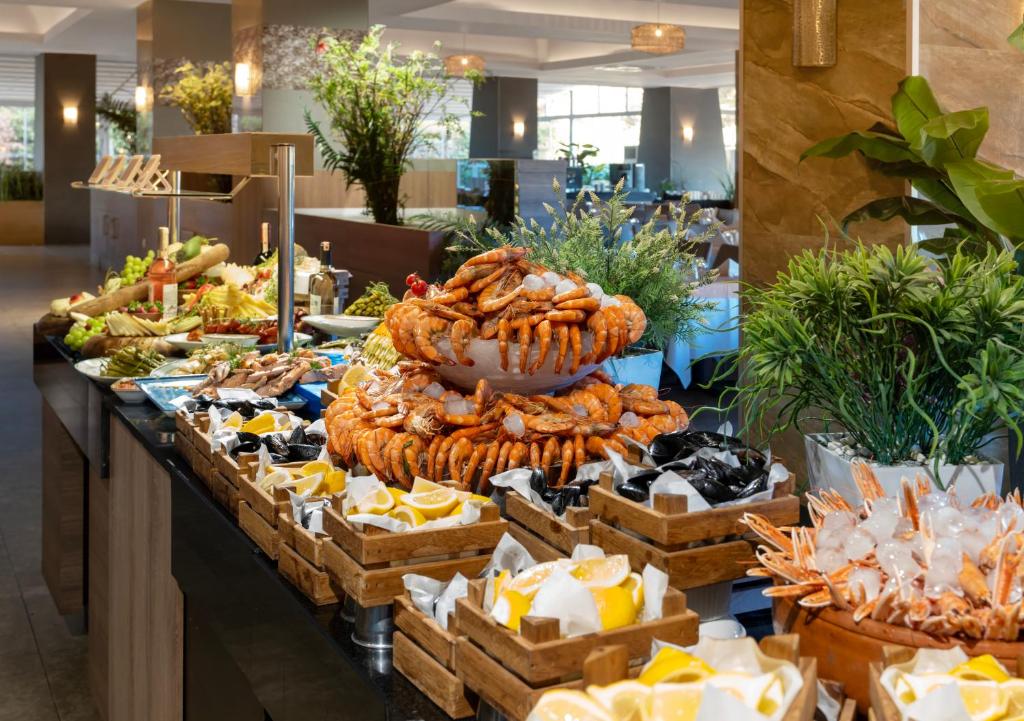 a buffet of food on display in a restaurant at Liberty Kuşadası in Kusadası