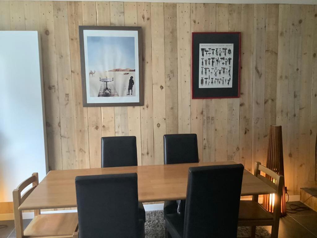a dining room with a wooden table and chairs at Appartement Thout dichtbij zee in Ostend