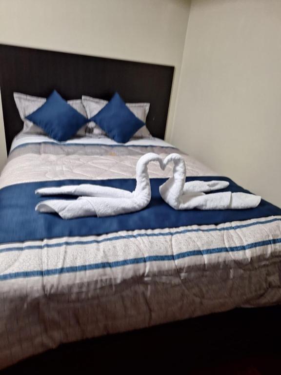 Postel nebo postele na pokoji v ubytování Hostal San Antonio Inn