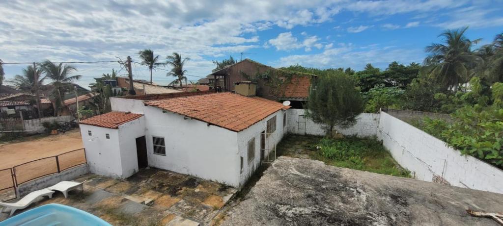 un pequeño edificio blanco con techo rojo en Pousada Flores Maceió, en Maceió