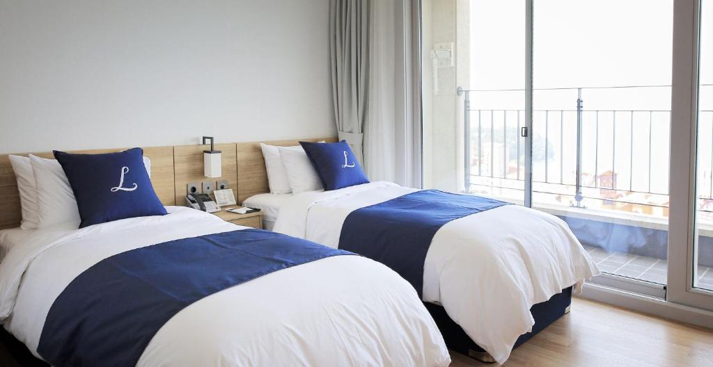 Postel nebo postele na pokoji v ubytování Lapis Hotel Namhae