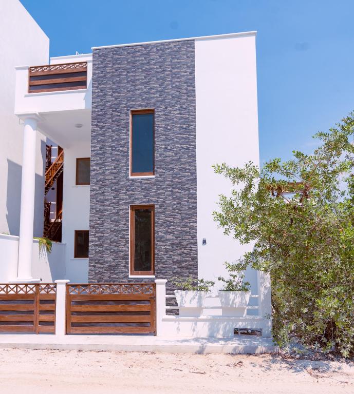 a house with a wooden fence in front of it at Casa La Martina Holbox in Holbox Island