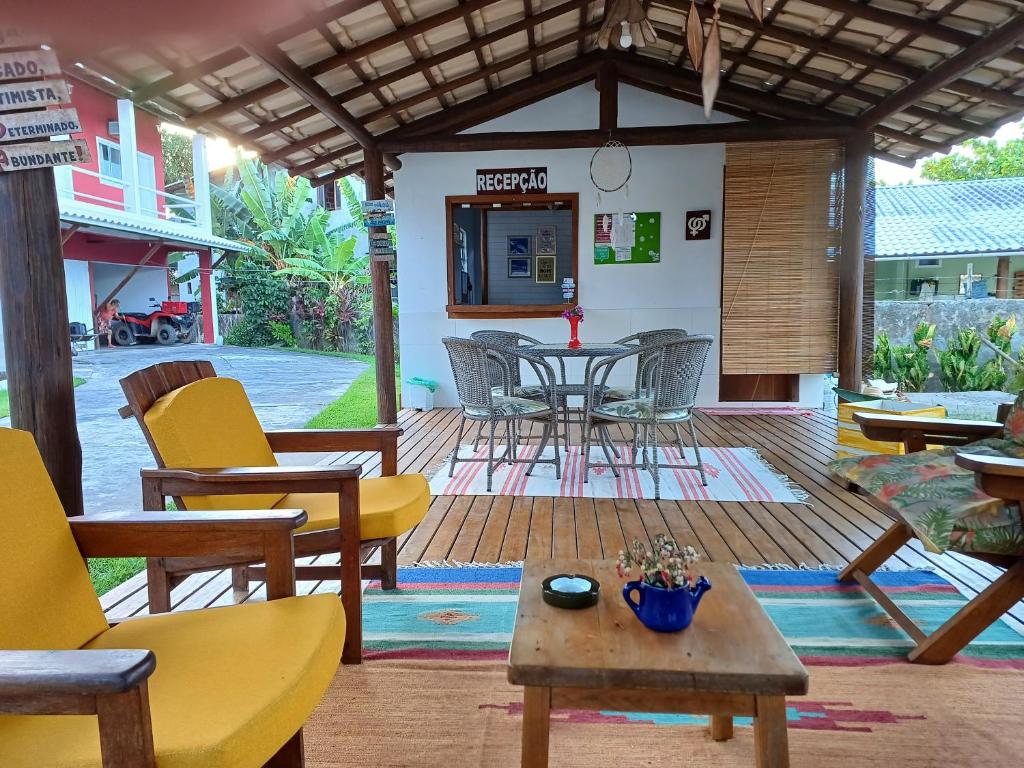 a patio with chairs and tables and a table at Morada das Palmeiras in Barra Grande