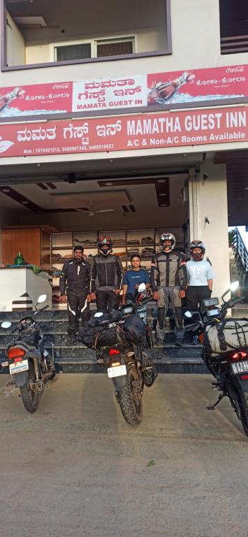 a group of motorcycles parked in front of a store at Mamatha Guest inn in Hampi
