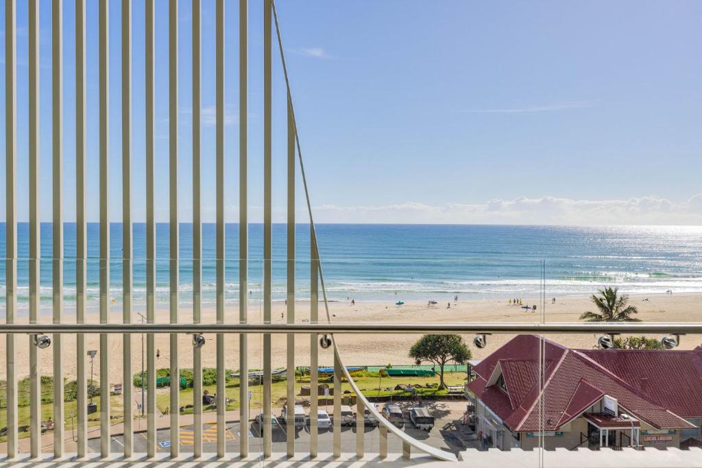 a view of the beach from a balcony of a building at Little Groyne Kirra Beach Unit 602 in Gold Coast