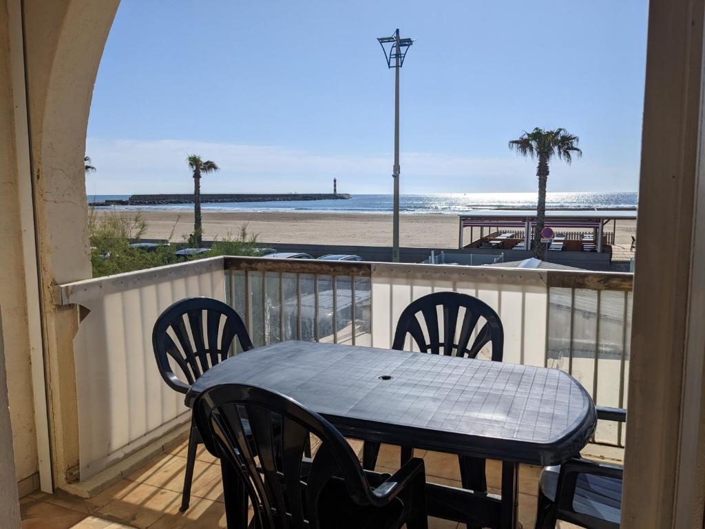 une table et des chaises sur un balcon avec vue sur la plage dans l'établissement T3 duplex 50m², 2 chambres, proche plage, 6 pers - FR-1-797-1, à Port-la-Nouvelle