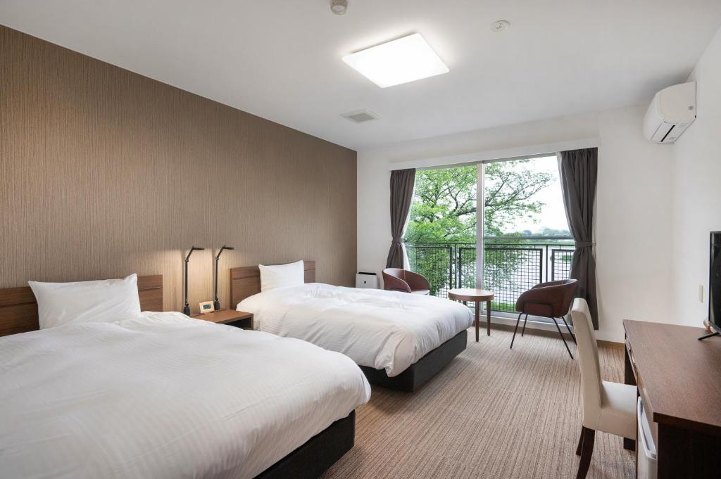 Postel nebo postele na pokoji v ubytování 里沼リゾート　Hotel KOMORINU