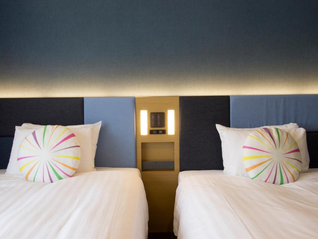 Postel nebo postele na pokoji v ubytování Hearton Hotel Kyoto