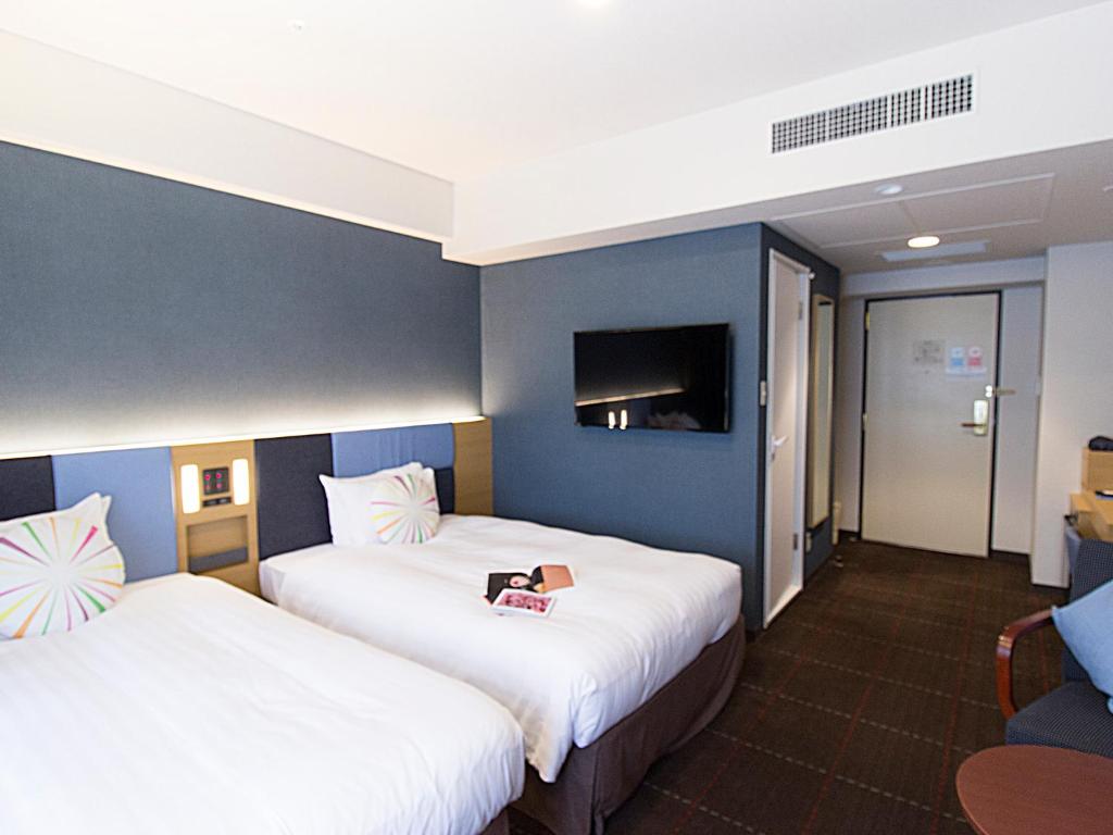 Postel nebo postele na pokoji v ubytování Hearton Hotel Kyoto