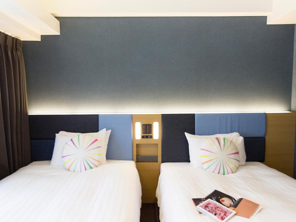 Postel nebo postele na pokoji v ubytování Hearton Hotel Kyoto