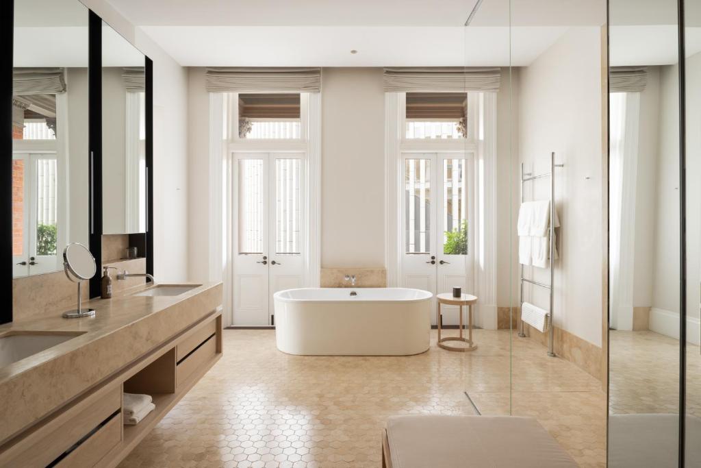 a large bathroom with a tub and a sink at COMO The Treasury in Perth