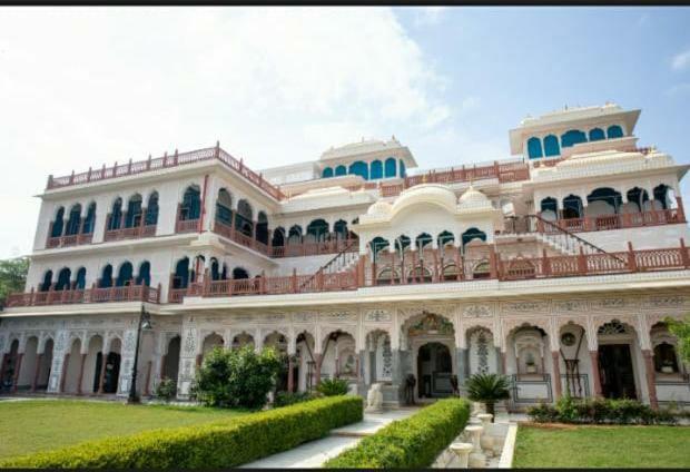 a large white building with a lawn in front of it at Shahpura Haveli in Shāhpura