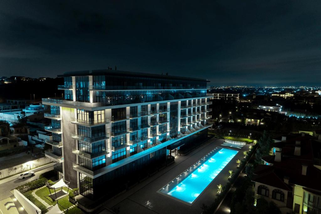 a large building with a swimming pool at night at Sea Breeze Lighthouse 3 in Baku