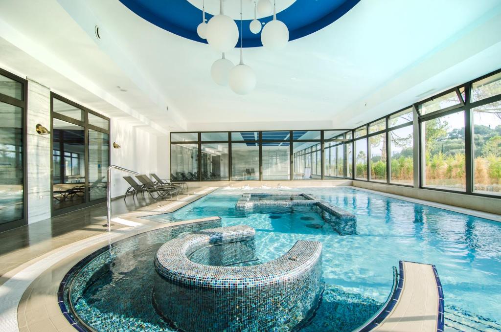 a large swimming pool in a building at Liberty Kuşadası in Kusadası