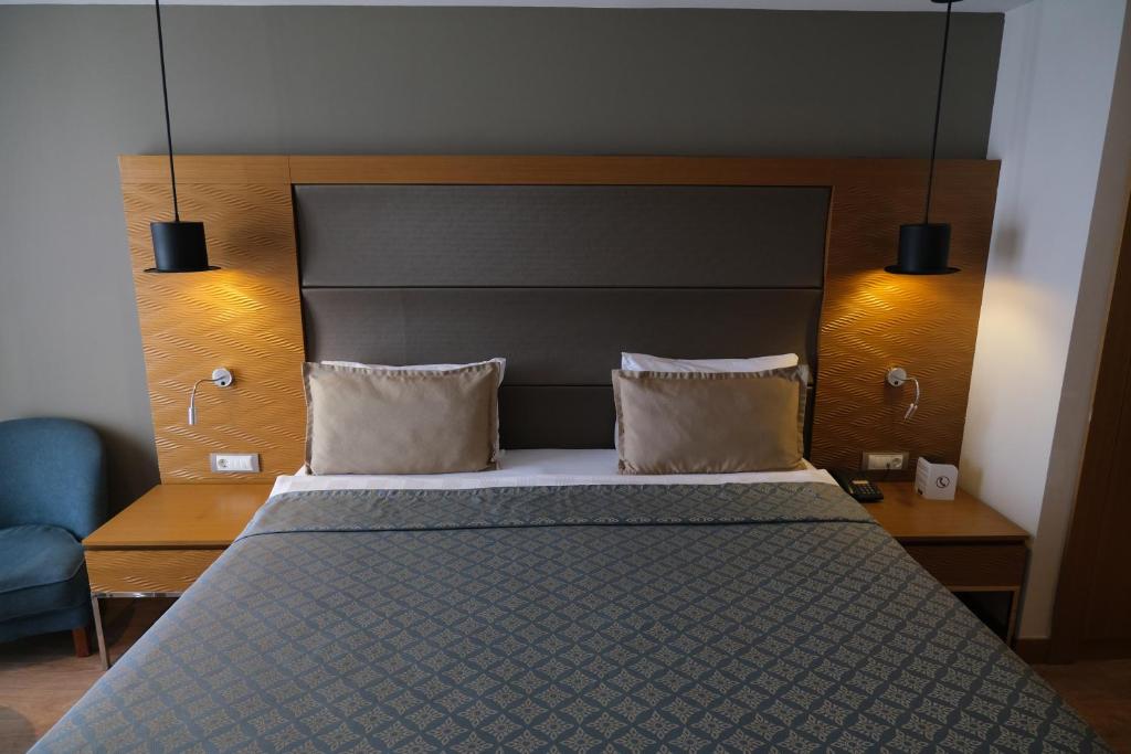 a bedroom with a large bed with two pillows at Liberty Kuşadası in Kusadası