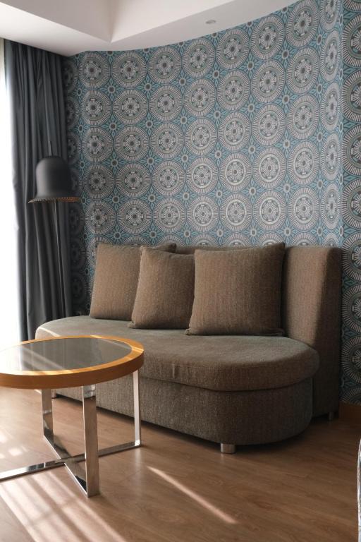a living room with a couch and a table at Liberty Kuşadası in Kusadası