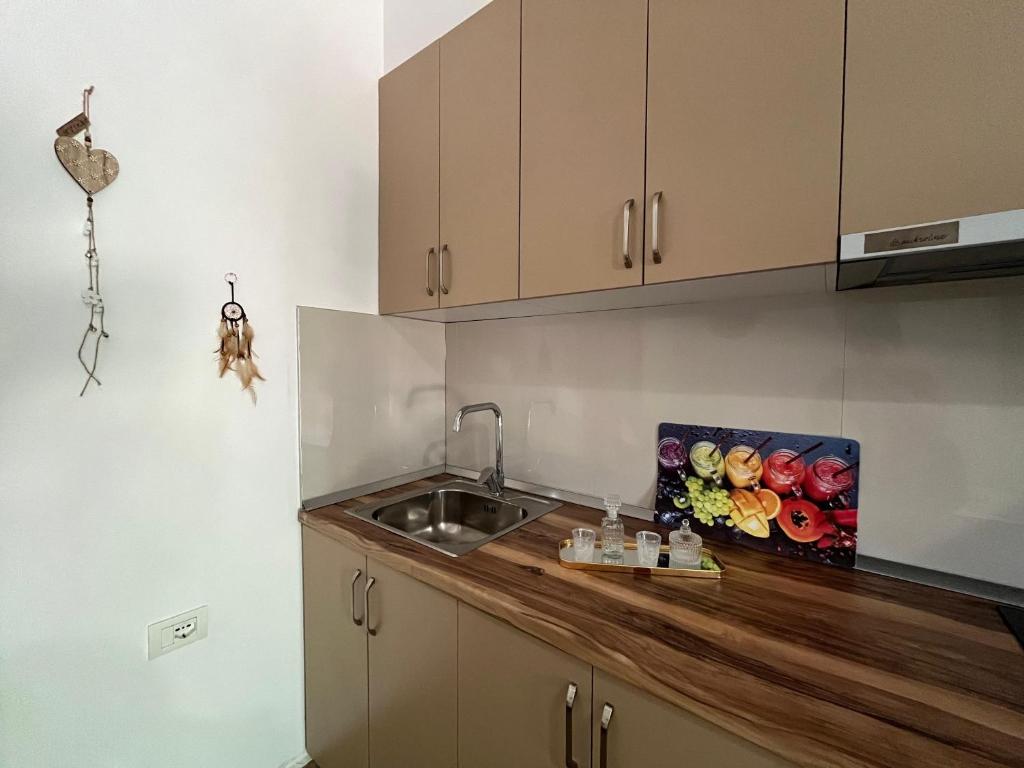 a kitchen with a sink and a wooden counter top at Doris Apartments in Himare