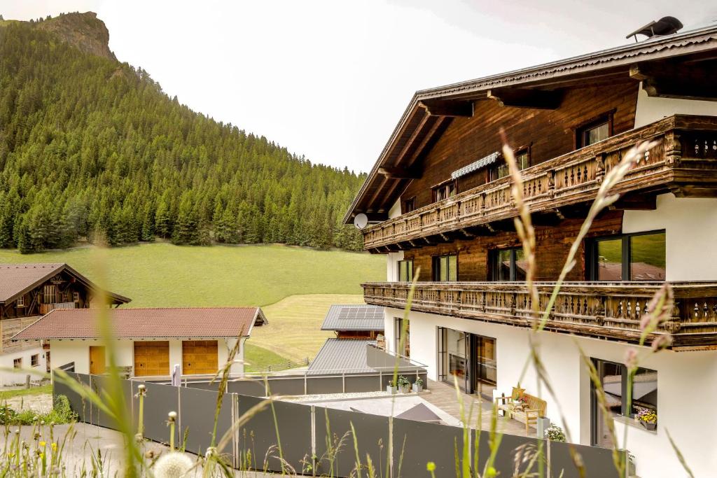 a large building with a mountain in the background at WOLF Apartments Padaun - Panorama Mountain Retreat in Tirol in Vals
