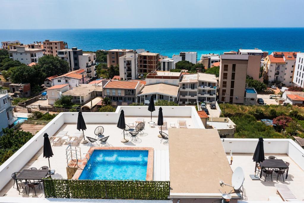 a view of a resort with a swimming pool and the ocean at Apartmani BLUE MOON in Dobra Voda