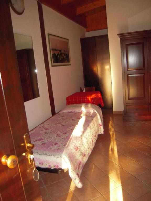 Łóżko lub łóżka w pokoju w obiekcie Agriturismo il Contadino