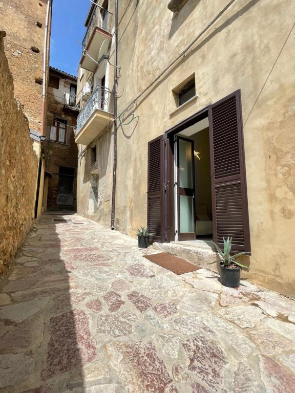 an alley in a building with tiles on the ground at Cozy Studio in Pisciotta