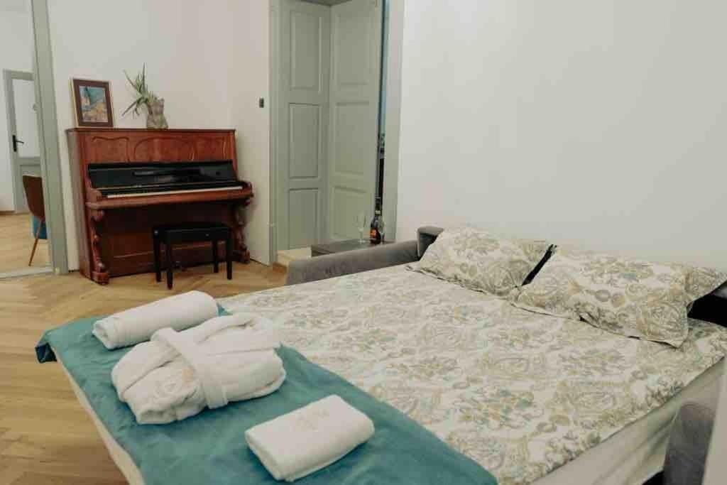 a bedroom with a bed with towels on it at Downtown luxury segment in Braşov