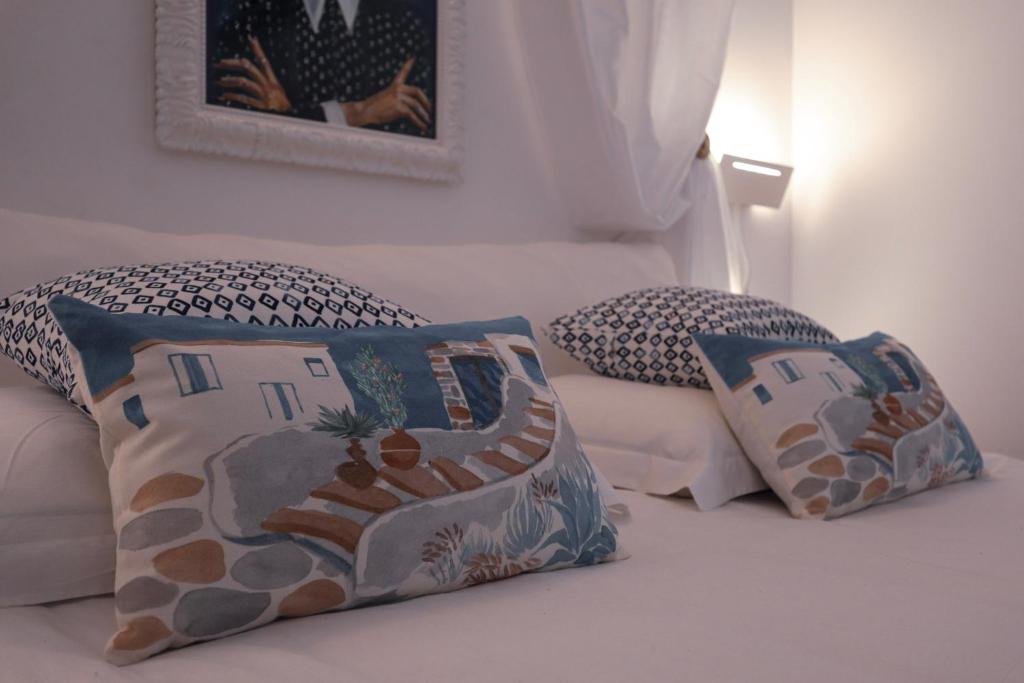 a bedroom with two pillows on a bed at The White Knight Premium Boutique Hotel in Għajnsielem