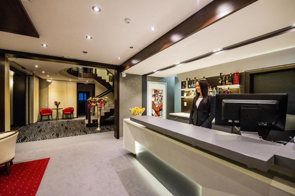 a woman standing at a counter in a store at Boutique Hotel Villa ZAUBER in Poprad