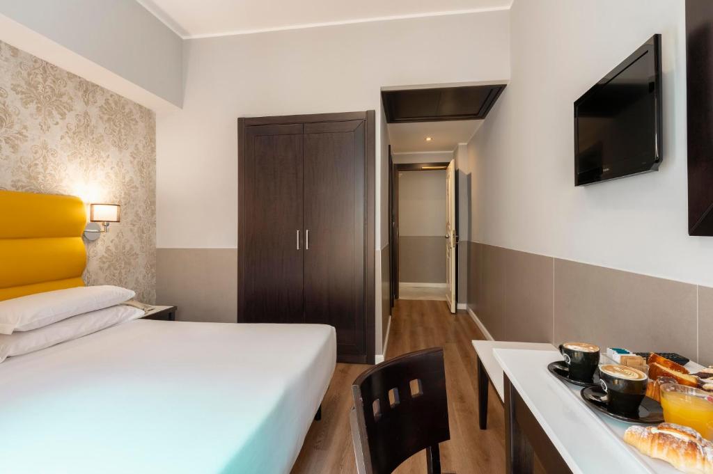Cama ou camas em um quarto em Hotel Virgilio